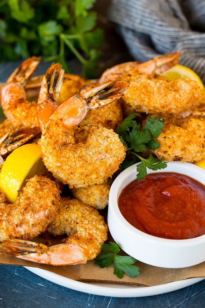 A plate of air fryer shrimp served with cocktail sauce.