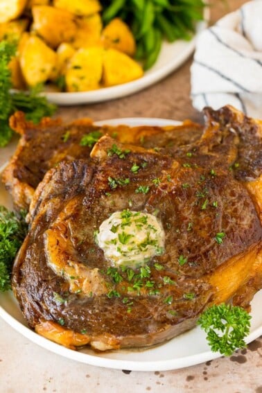 Air Fryer steak with garlic butter and herbs on top.