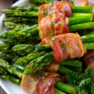 Bacon wrapped asparagus on a serving plate.