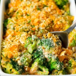 A pan of broccoli casserole with a serving spoon in it.