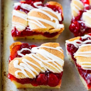 Cherry bars made with almond cookie dough on a sheet pan.