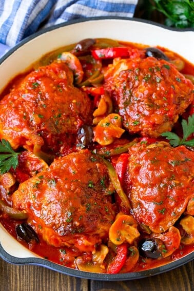 Chicken cacciatore with chicken thighs, peppers, olives and mushrooms in tomato sauce.