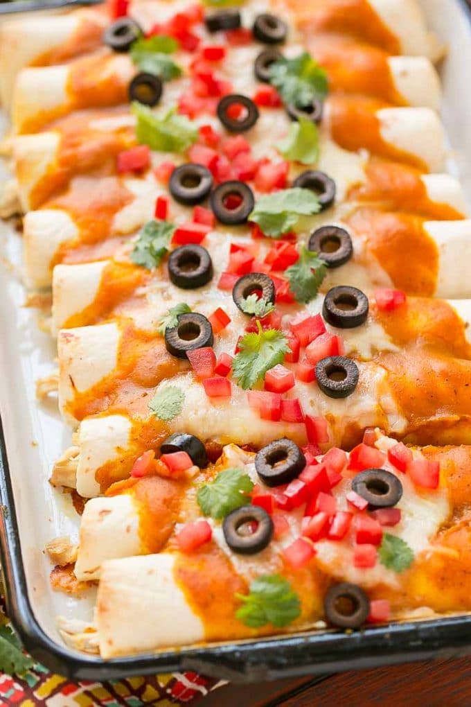 A view of Mexican toppings on a tray of pumpkin enchiladas.