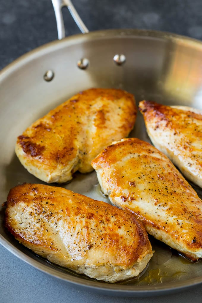 Seared chicken breasts in a skillet.