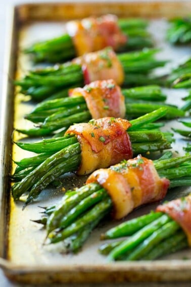 A row of green bean bundles on a pan.