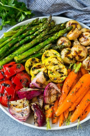 A colorful platter of grilled vegetables flavored with garlic and herbs.