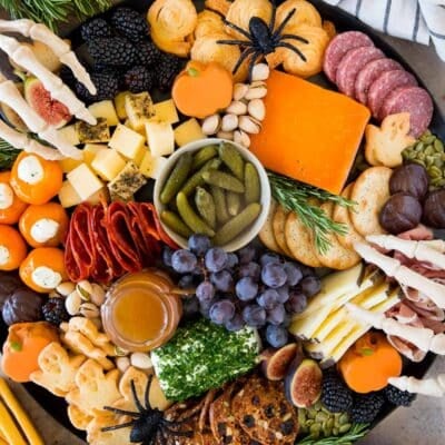 A Halloween charcuterie board filled with meats, cheeses, crackers and Halloween sweets.