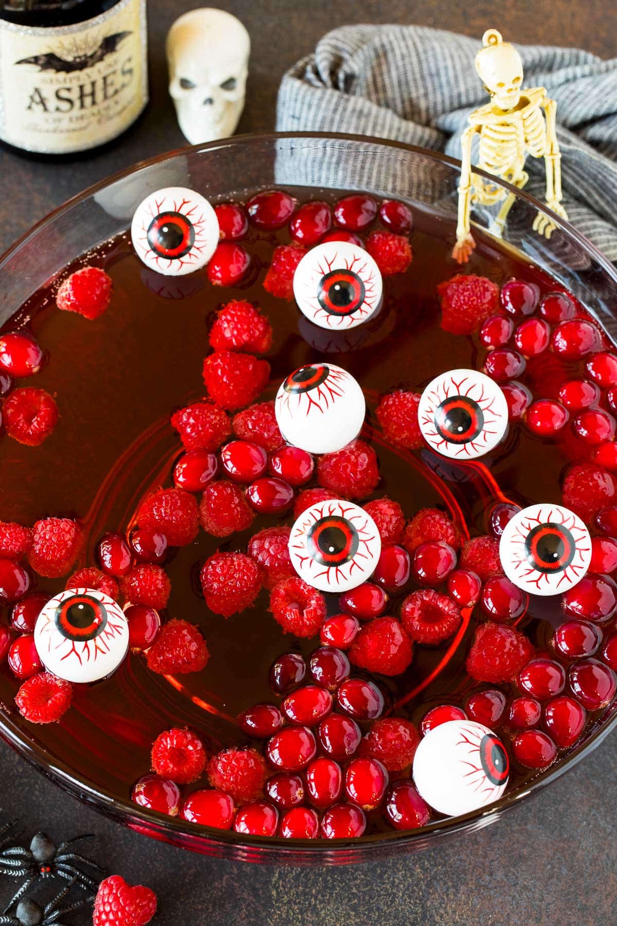 A bowl of Halloween punch with raspberries and cranberries floating in it.