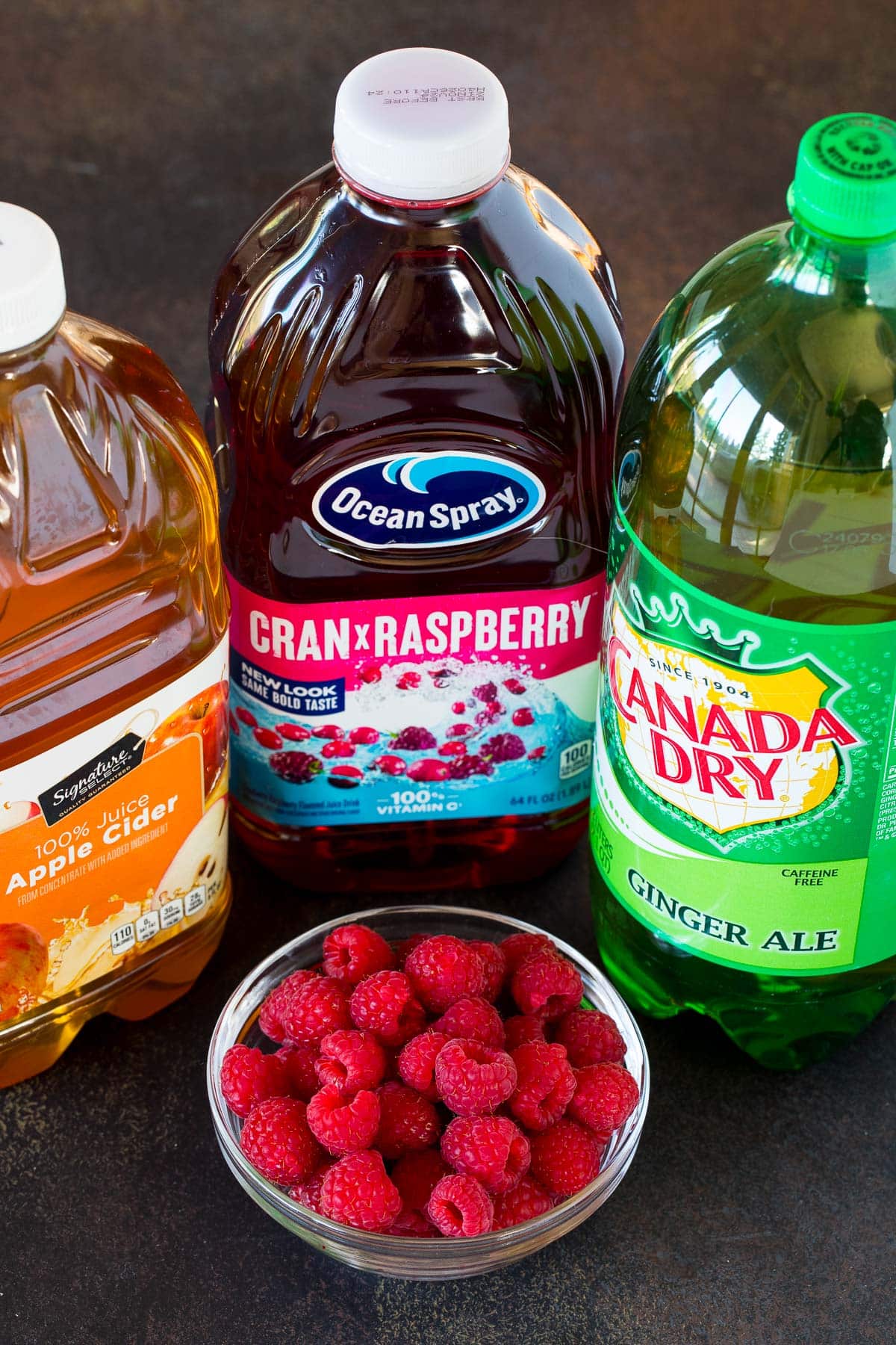 Bottles of ginger ale, cranberry raspberry juice and apple cider.