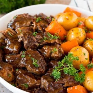 Instant Pot pot roast with carrots and potatoes, all topped with parsley.