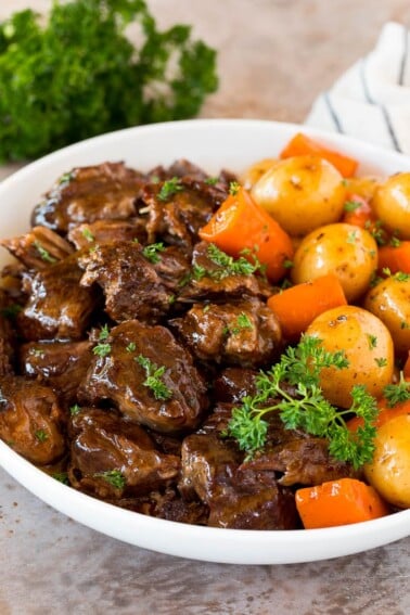 Instant Pot pot roast with carrots and potatoes, all topped with parsley.