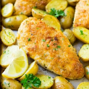 Italian chicken with a parmesan crust, along with roasted potatoes and parsley.