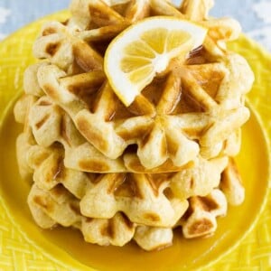 This recipe for lemon waffles made with sour cream are light and fluffy with the perfect amount of tang. Serve these waffles with maple syrup or lemon curd for the perfect weekend breakfast!