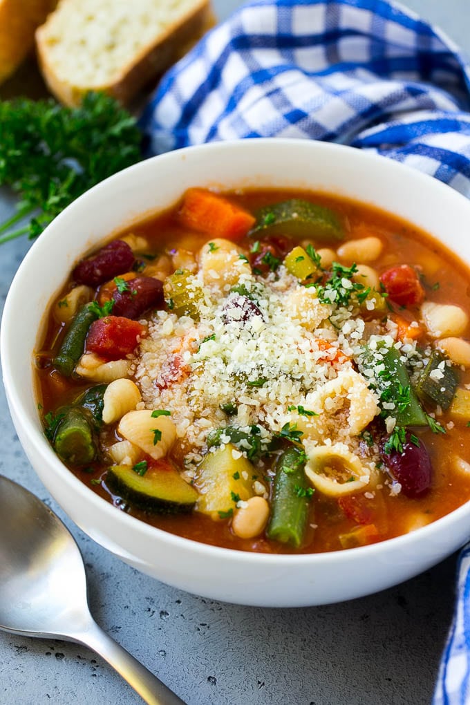 A bowl of Olive Garden minestrone soup topped with parmesan cheese.