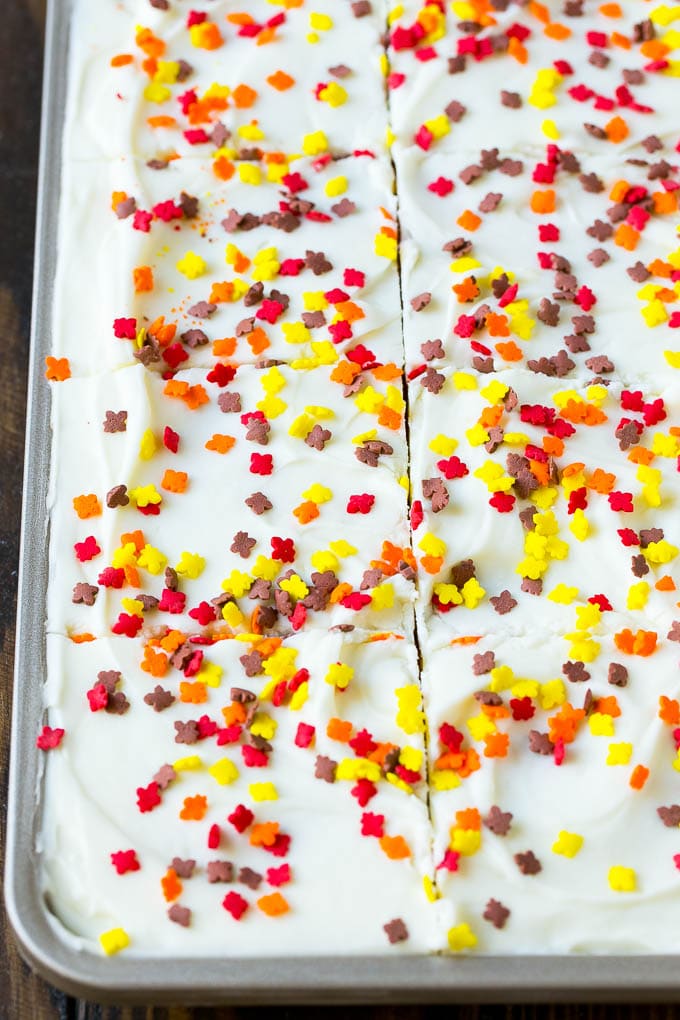 Cream cheese frosting and sprinkles spread over cake.