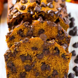 Sliced pumpkin chocolate chip bread on a serving board.