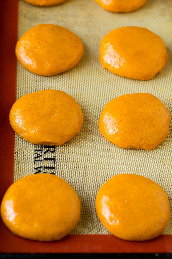 Rounds of cookie dough on a sheet pan.