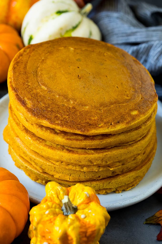 A stack of hot cakes surrounded by fall decorations.