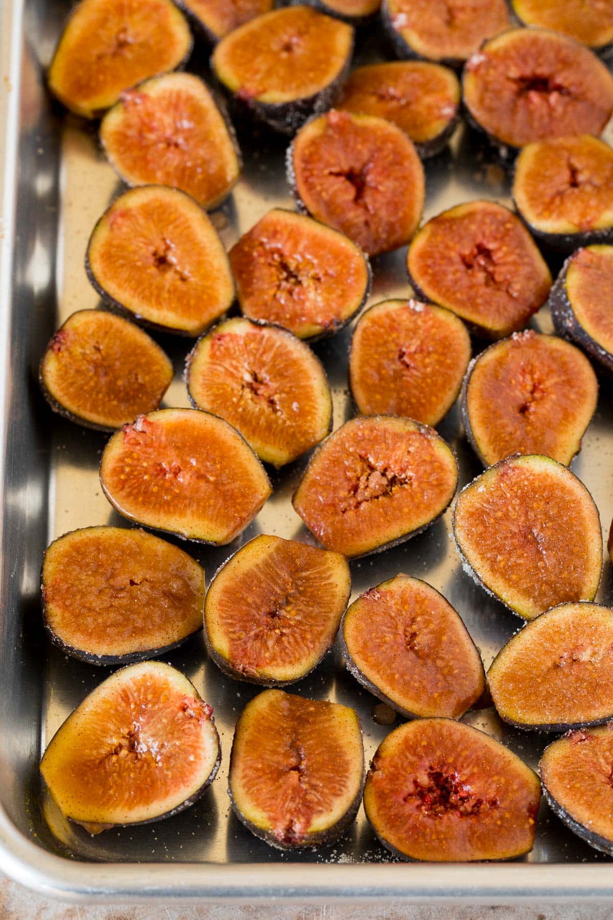 Figs cut in half on a sheet pan.