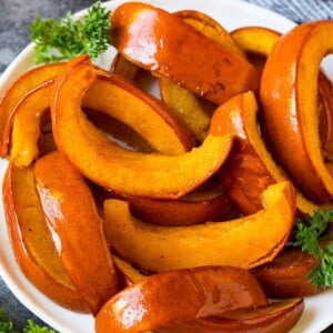 Slices of roasted pumpkin on a serving plate.