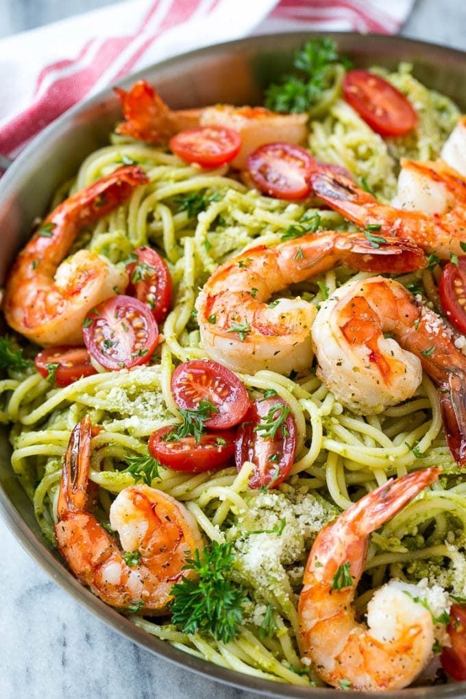 Seared shrimp served over spaghetti tossed in pesto sauce.