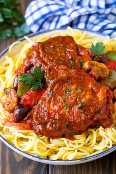 Slow cooker chicken cacciatore served over pasta.