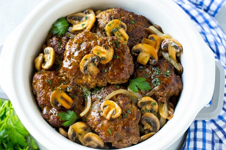 A crock pot full of slow cooker salisbury steak.