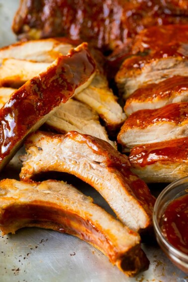 Sliced smoked ribs brushed with BBQ sauce.