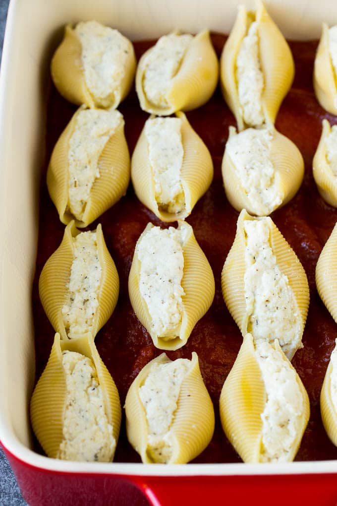 Pasta filled with cheese on a bed of tomato sauce.