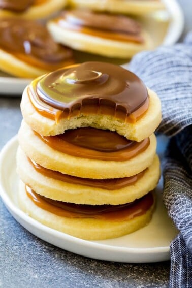 A stack of Twix cookies with a bite taken out of one.